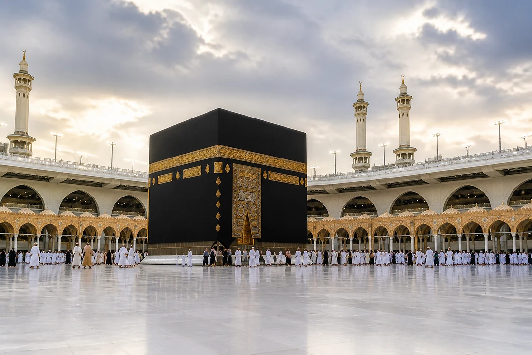 The Kaaba at Masjid al-Haram surrounded by distant pilgrims beneath a softly dramatic sky